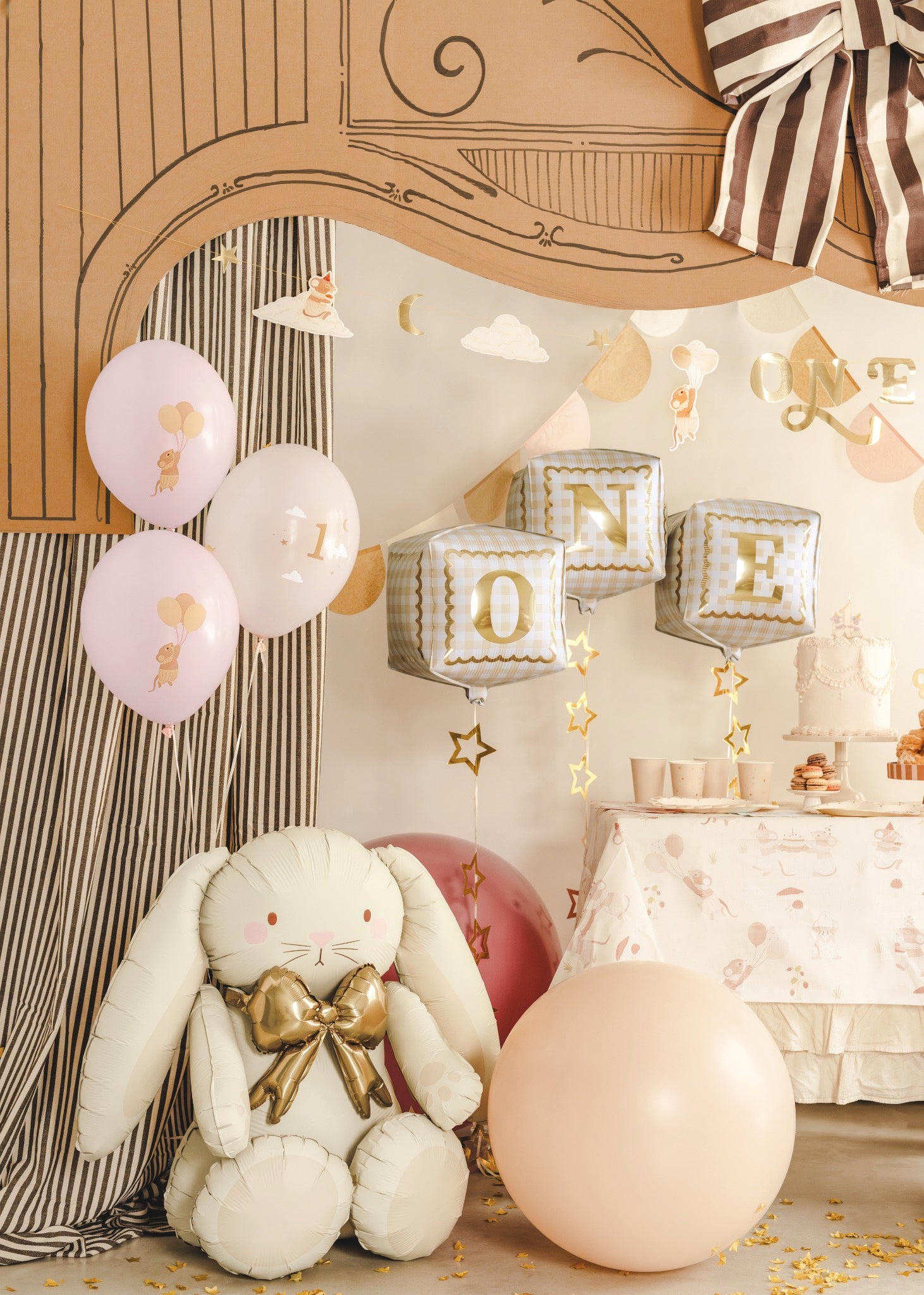 Decorative setting with balloons, a plush bunny, and 'ONE' balloons for a first birthday celebration.