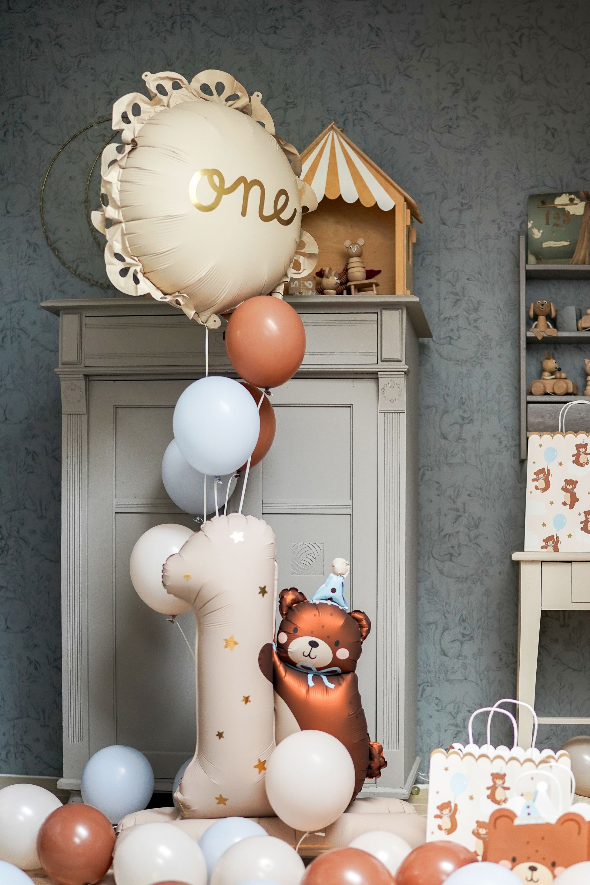 Large number one foil balloon with teddy bear design, perfect for first birthday decorations
