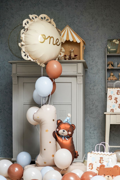 Large number one foil balloon with teddy bear design, perfect for first birthday decorations