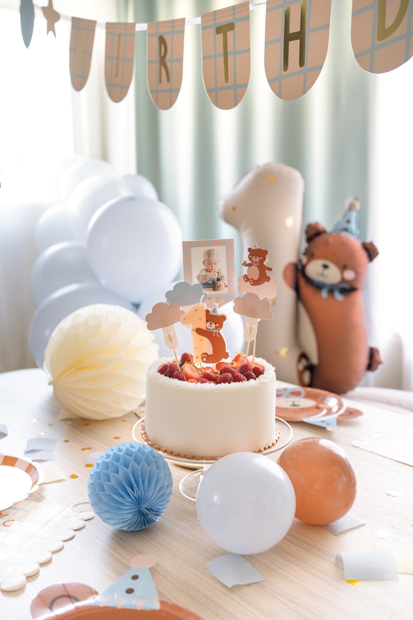 Birthday candle shaped as number one with adorable teddy bear hugging it, perfect for first birthday cakes