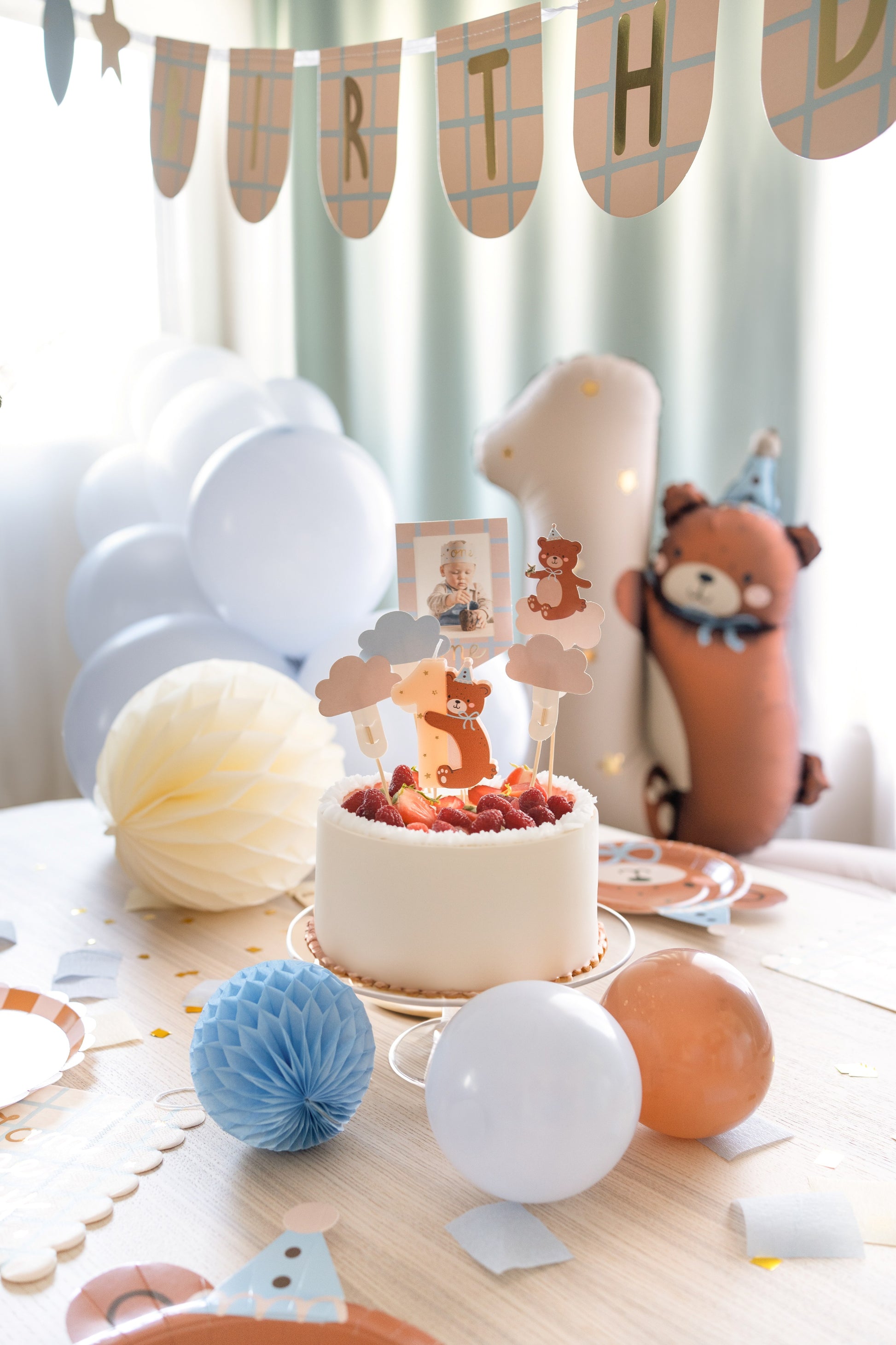 Birthday candle shaped as number one with adorable teddy bear hugging it, perfect for first birthday cakes
