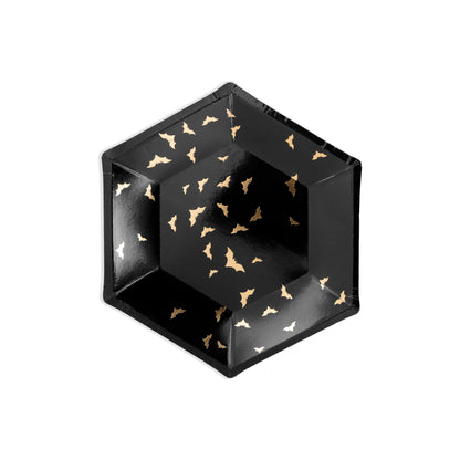 Black hexagonal plates with gold bat patterns on a white background