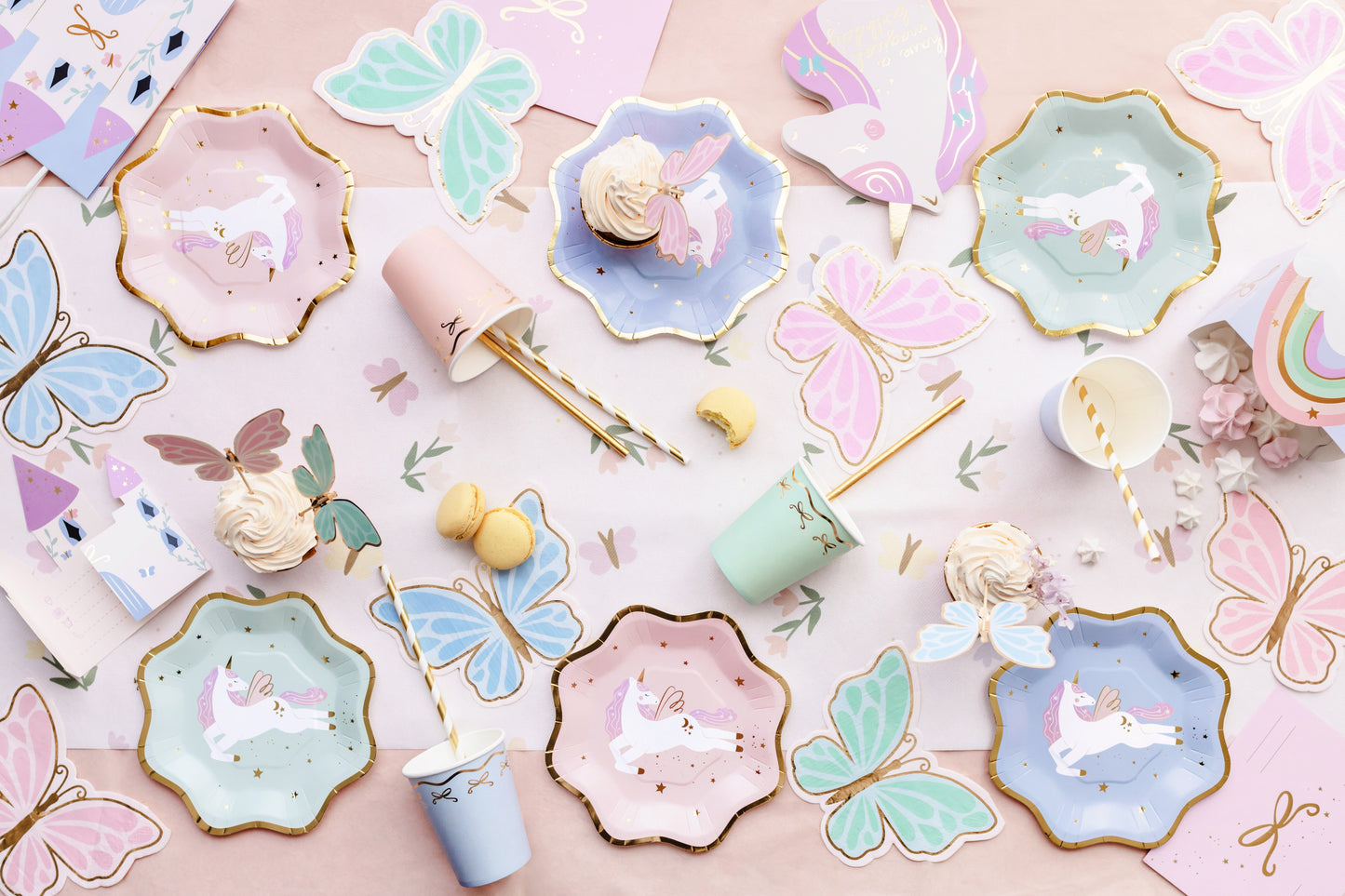 Pastel unicorn paper tableware in blue, mint, and pink with gold trim – party tableware