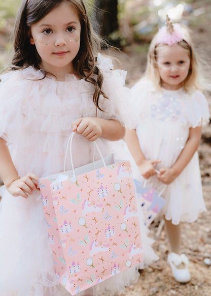 Pink gift bag with unicorns, castles, and butterflies – fairy tale party goodie bag