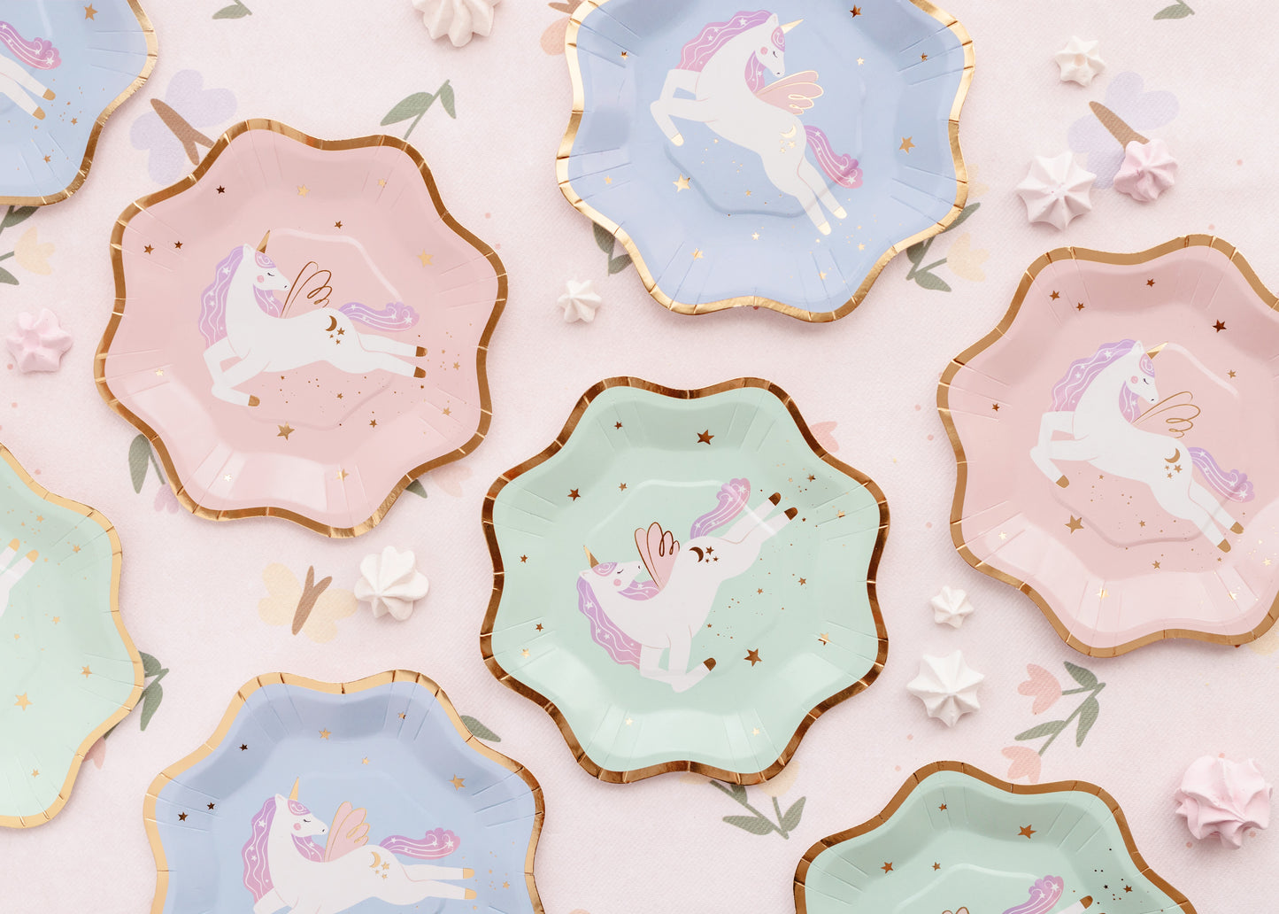 Pastel unicorn paper plates in blue, mint, and pink with gold trim – party tableware