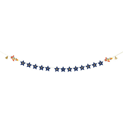 Birthday banner with "Happy Birthday" text on navy blue stars, decorated with rocket illustrations.
