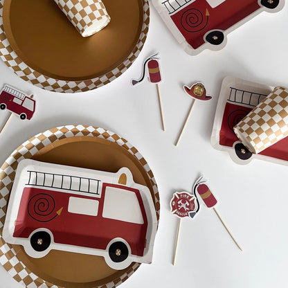 Fire truck-themed paper plates and flags on a white background