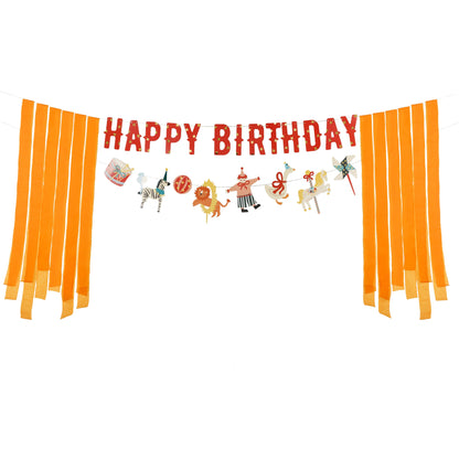 Colorful circus-themed 'Happy Birthday' banner with illustrations of animals, circus elements and hanging orange ribbons on both sides