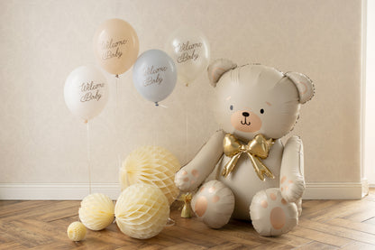 Balloon shaped like a teddy bear with decorative balloons on a wooden floor.