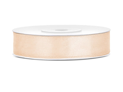 Roll of beige ribbon on a white background