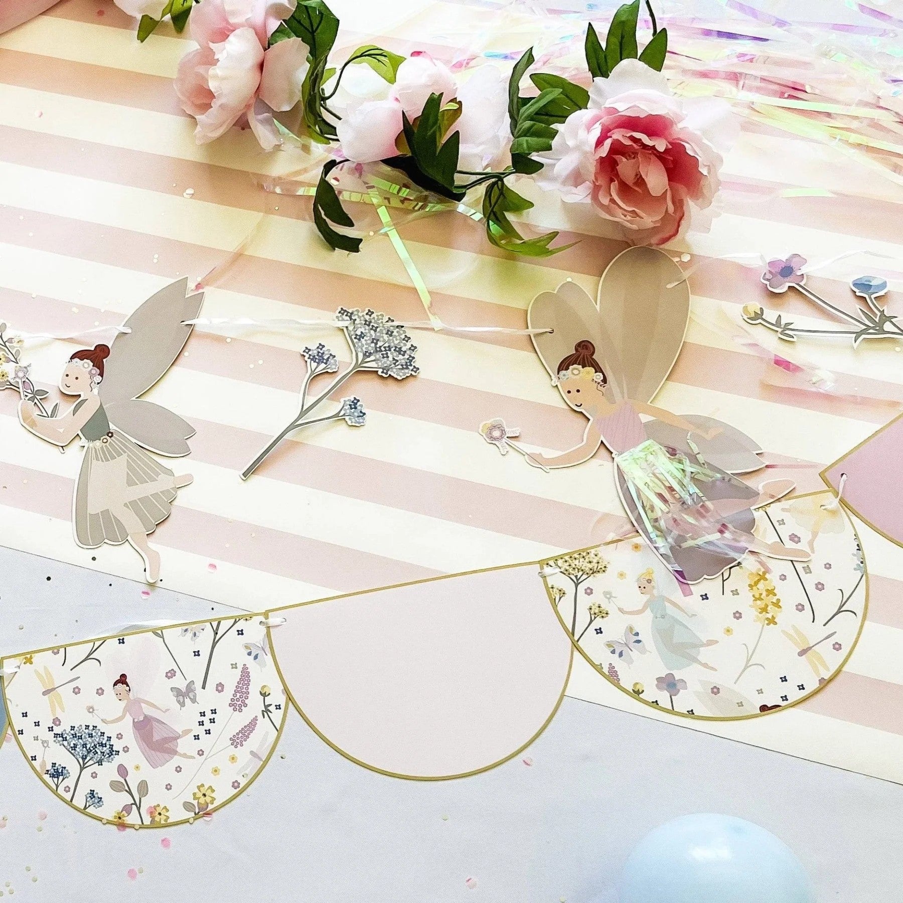 Decorative garland with fairy designs on a striped background