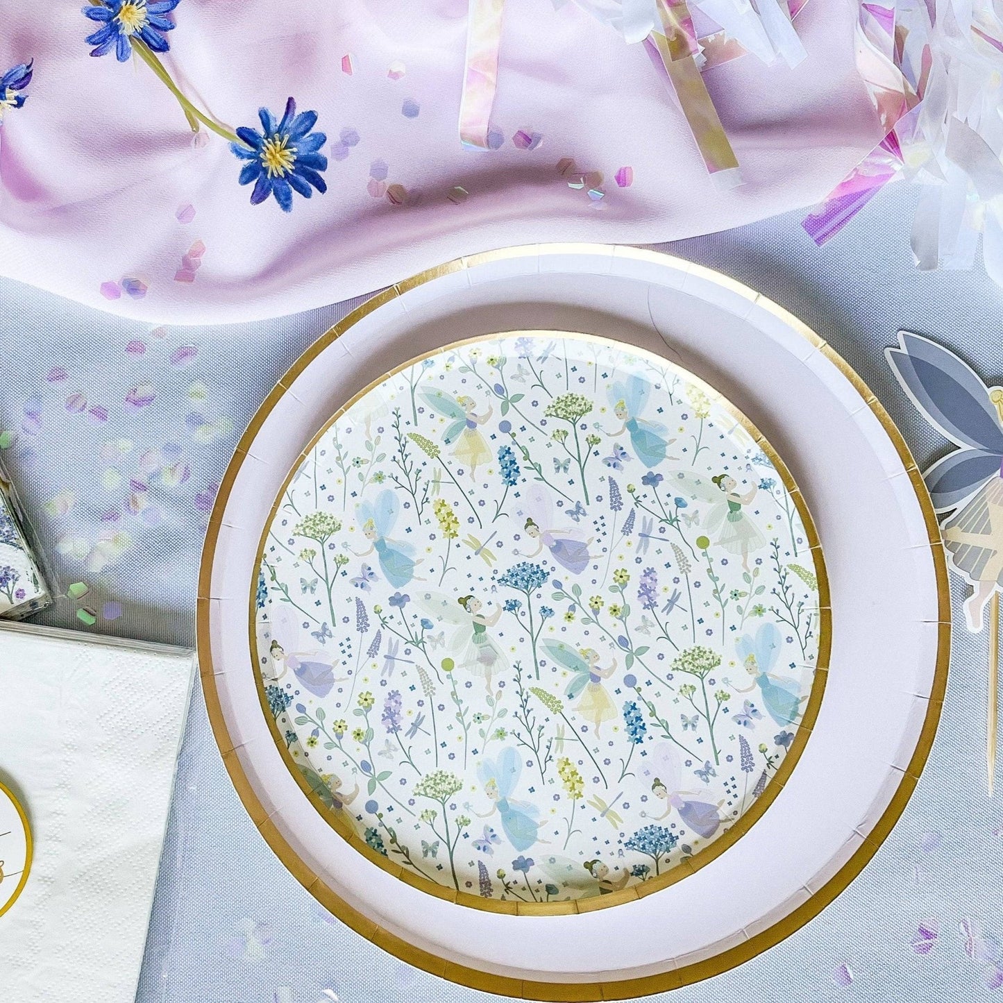 Round decorative plate with floral pattern on a light blue background