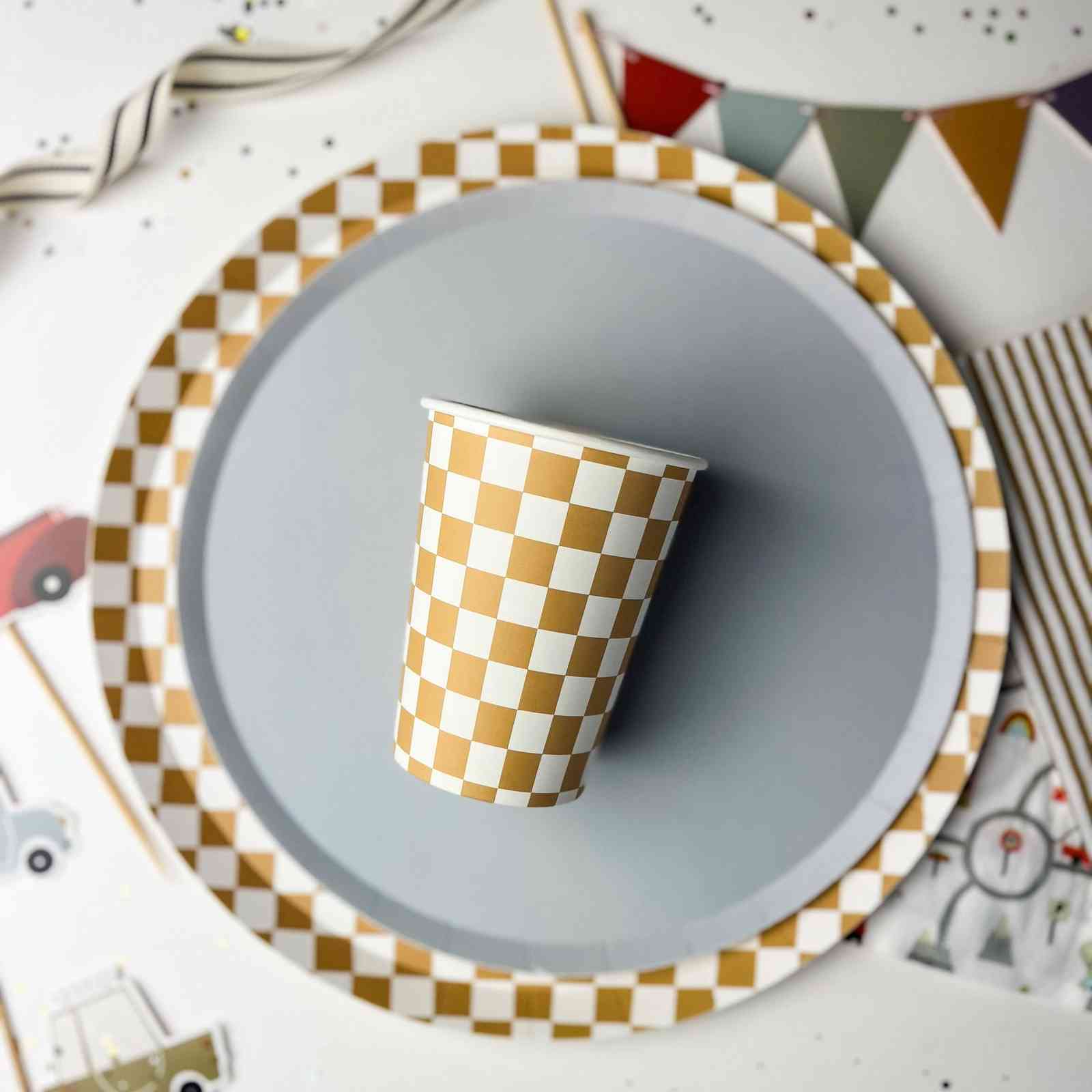 Checkered paper cup on a gray plate with a colorful background
