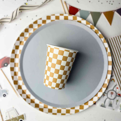 Checkered paper cup on a gray plate with a colorful background