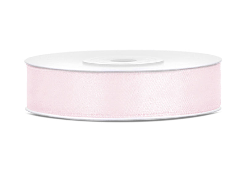 Roll of pink ribbon on a white background