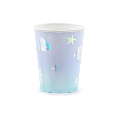 Light blue paper cups with holographic seashell and star illustrations — ocean party tableware.