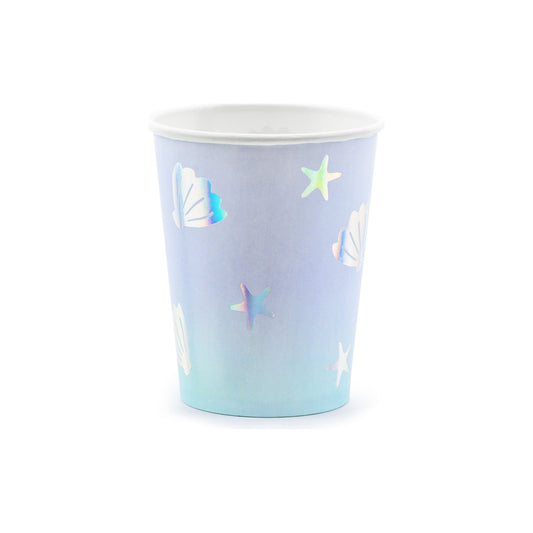 Light blue paper cups with holographic seashell and star illustrations — ocean party tableware.