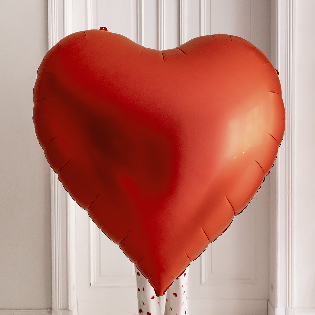 Red heart-shaped foil balloon.
