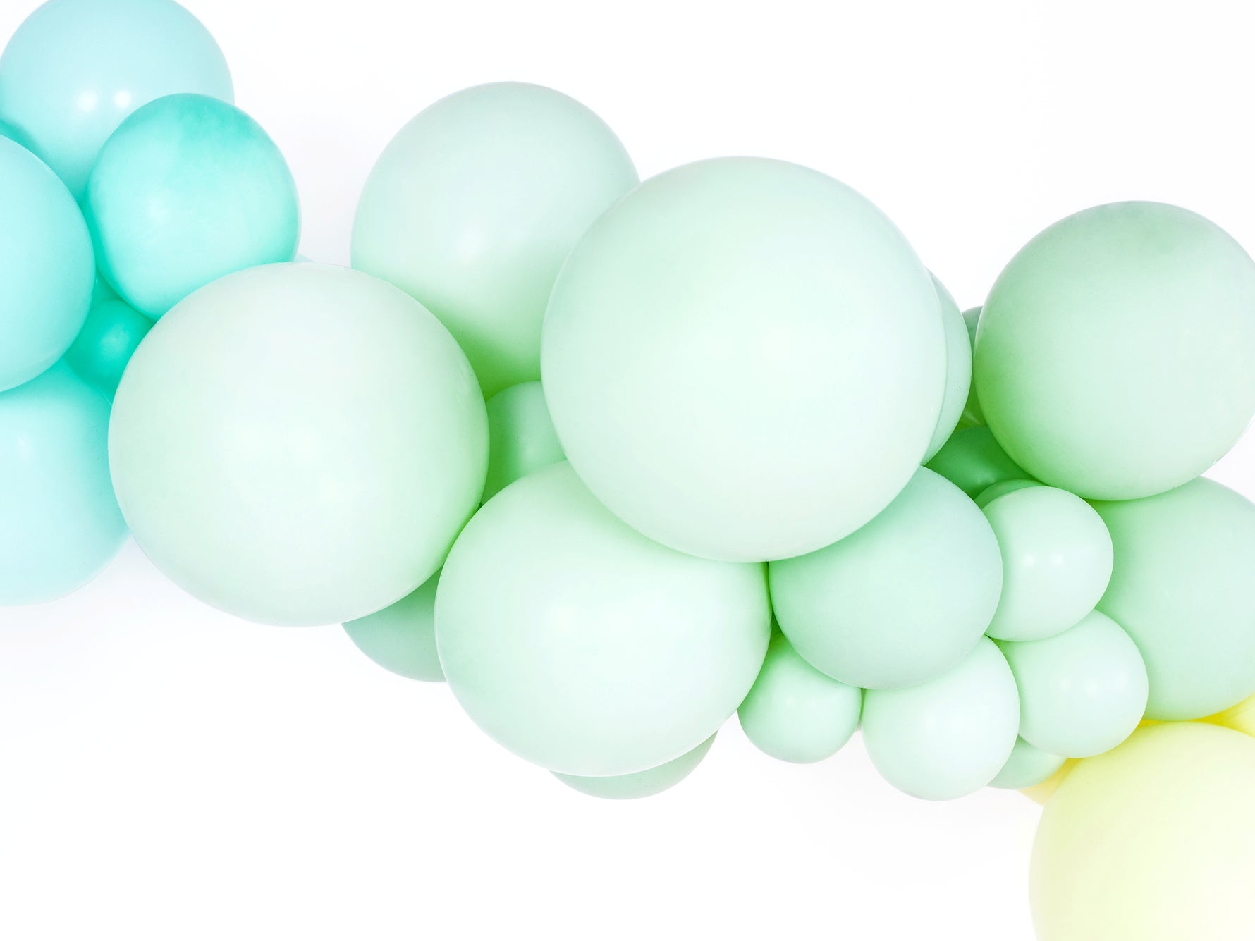 Mint green balloons arranged in a garland on a white background