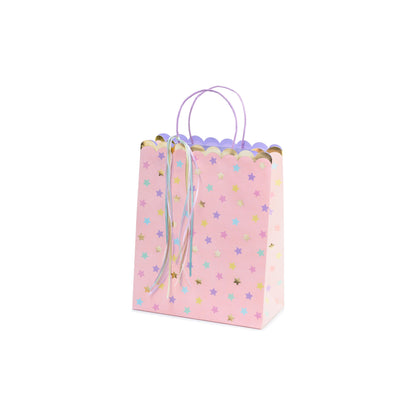 Pink gift bag with pastel stars and ribbons – unicorn-themed party favor bag