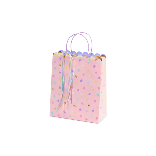 Pink gift bag with pastel stars and ribbons – unicorn-themed party favor bag